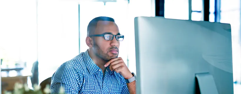 a man looking at his computer screen