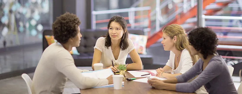 a group of people in a meeting in an office discussing retention strategies