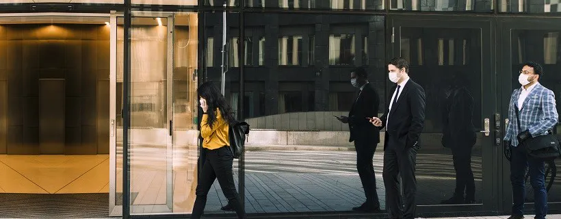 People walking past an office building