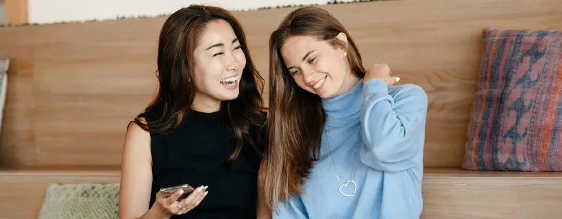 two female chatting and laughing 