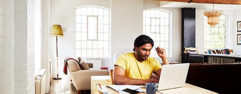 An employee working on their resignation letter at their desk from home